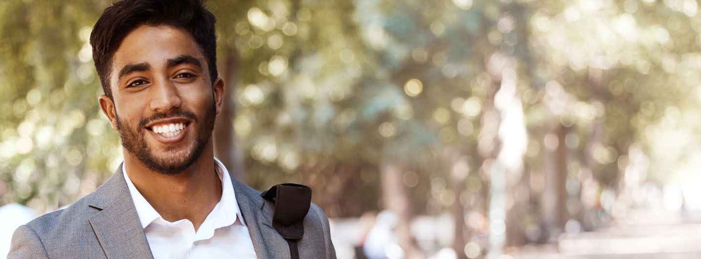 Professional man smiling in a park